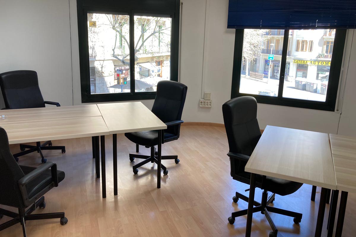 Mesas y sillas de trabajo con luz natural en una oficina de CREC Eixample Diagonal